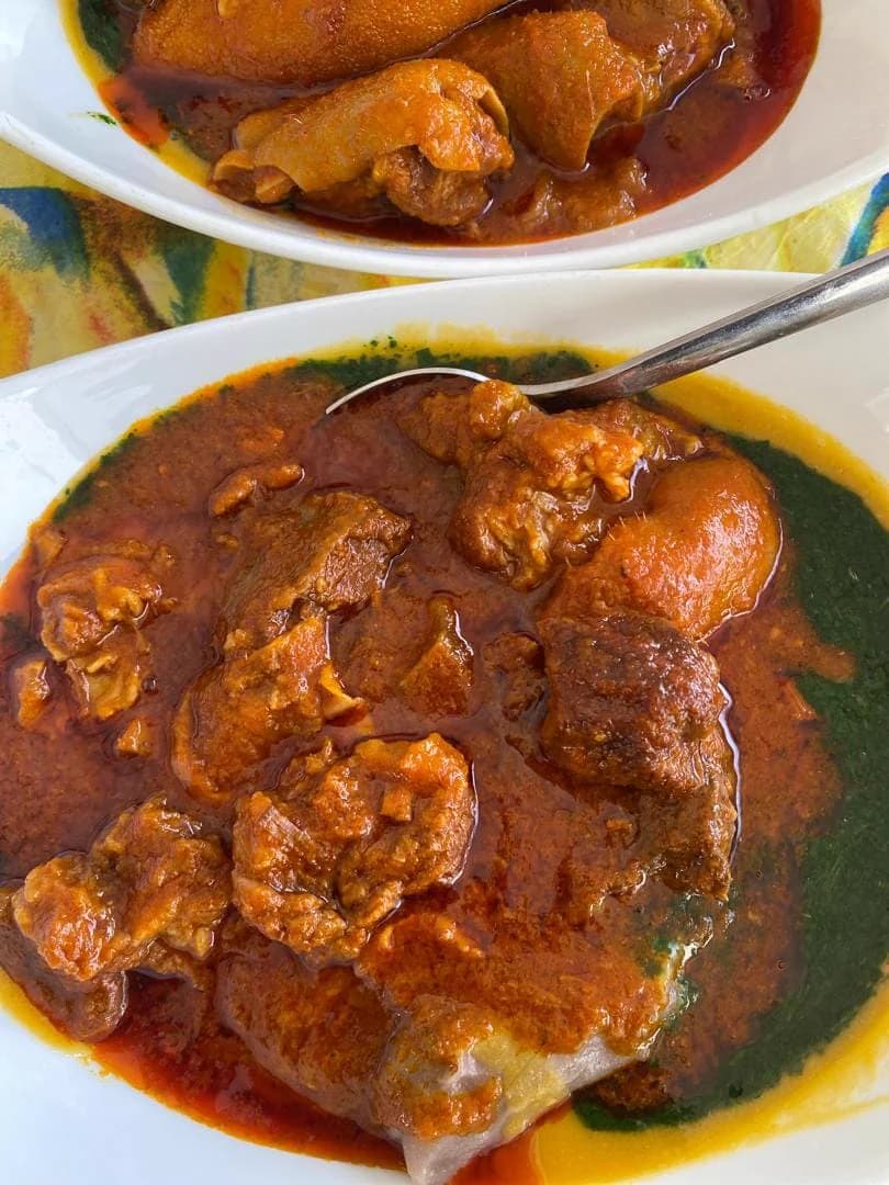 A bowl of ewedu and assorted meat stew served with swallow