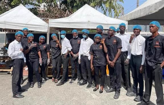The Dlawz Catering & Events service team in branded uniform at an outdoor event